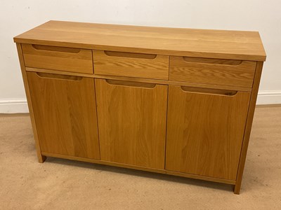 Lot 738 - A modern light oak dresser base with three...