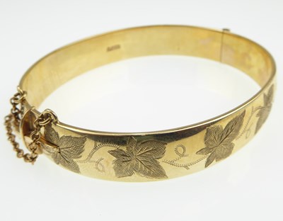 Lot 1121 - A 9ct gold hinged bracelet, half decorated in...