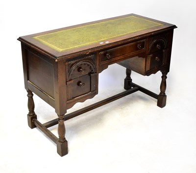 Lot 71 - OLD CHARM; an oak kneehole desk, with an...