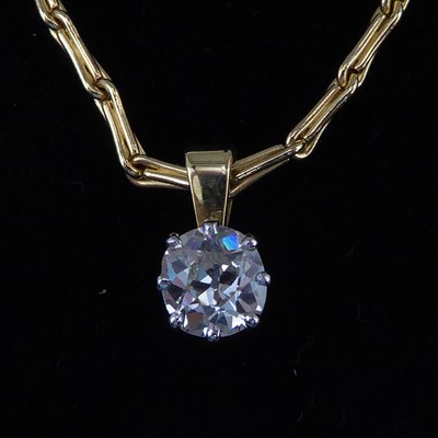 Lot 1164 - A diamond solitaire pendant with claw set...