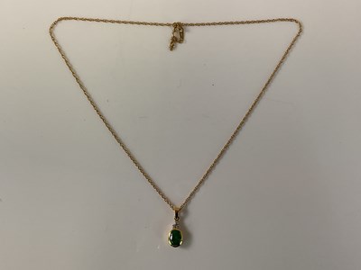 Lot 545 - An 18ct yellow gold emerald and three stone...
