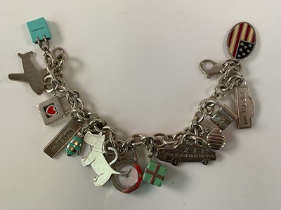 Lot 540 - TIFFANY & CO; a sterling silver charm bracelet,...