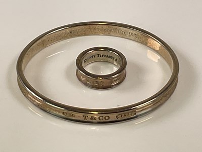 Lot 581 - TIFFANY & CO; an '1837' silver bangle and...