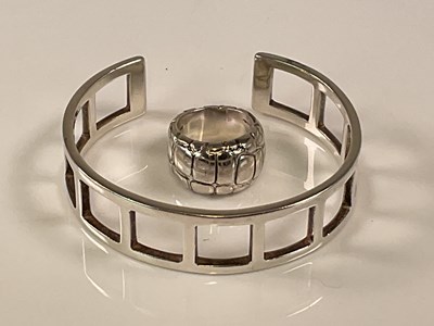 Lot 587 - GUCCI; a sterling silver openwork cuff bangle,...