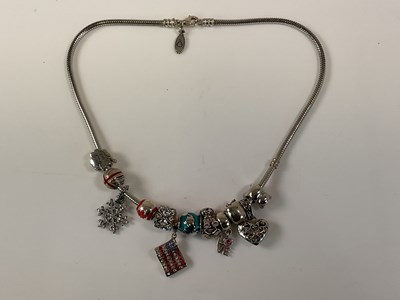 Lot 579 - PANDORA; a charm necklace set with numerous...