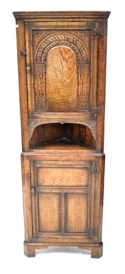 Lot 42 - A small reproduction oak corner cabinet in the...