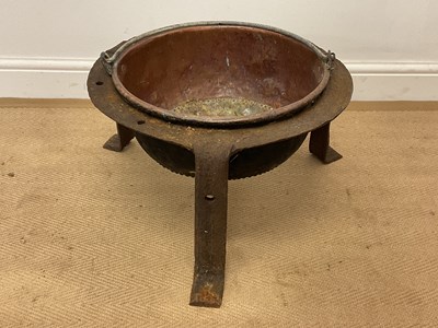 Lot 189 - A copper pot set with a forged iron stand on...