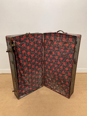 Lot 84 - A travel trunk with metal banding and a fitted...