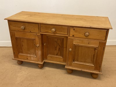 Lot 767 - A pine dresser base with three drawers over...
