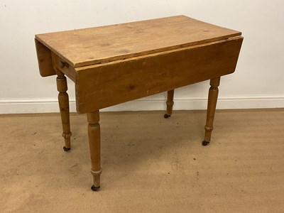 Lot 785 - A pine drop-leaf kitchen table with a single...