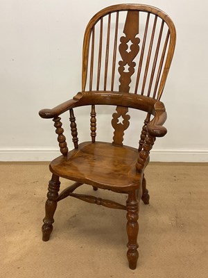 Lot 710 - An elm wood Windsor chair, height 118cm.