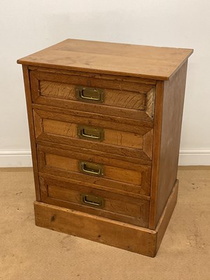 Lot 711 - A pine four drawer chest with brass handles,...