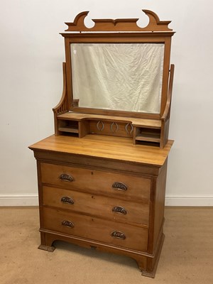 Lot 558 - An Arts and Crafts pine three drawer dressing...