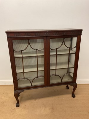 Lot 775 - A mahogany glazed display cabinet, raised on...