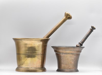 Lot 178 - Two 18th/19th century gun metal/brass pestles...