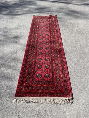 Lot 2521 - An Eastern red ground runner, with elephant...