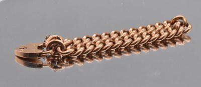 Lot 529 - A 15ct gold curb link bracelet with padlock...