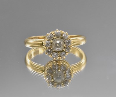 Lot 556 - An 18ct yellow gold diamond cluster ring, the...