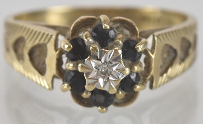 Lot 1370 - A 9ct gold sapphire and diamond ring, the...