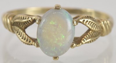 Lot 1344 - A 9ct gold opal ring, the oval opal with...