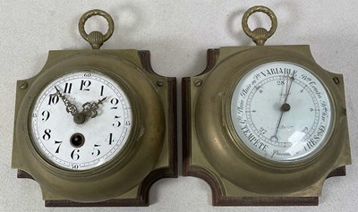 Lot 657 - A barometer and a clock, brass mounted on wood...