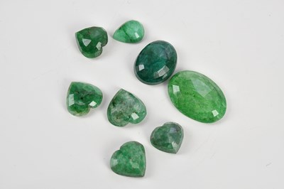 Lot 412 - Eight loose emeralds including five heart...