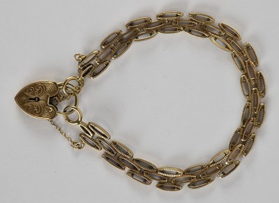Lot 1583 - A 9ct gold oval gate link bracelet, united by...