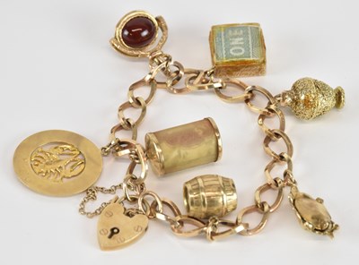 Lot 1573 - A 9ct gold charm bracelet, with seven charms...