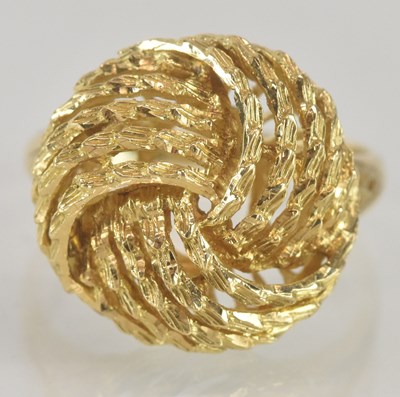 Lot 1256 - A bright gold ring with knot designed top,...