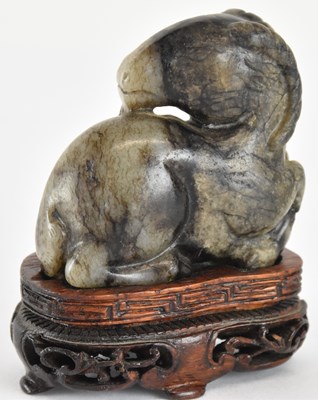 Lot 787 - An early 20th century carved pale grey and...