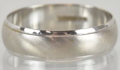 Lot 1250 - An 18ct white gold wedding band, size S,...