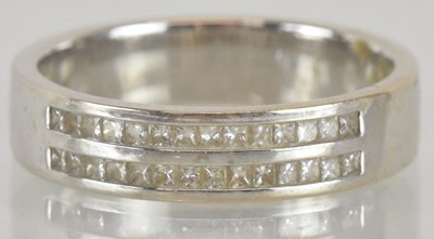 Lot 1252 - An 18ct white gold diamond set wedding band,...