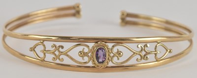 Lot 1618 - A 9ct yellow gold amethyst set bangle, the...