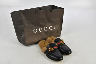 Lot 800 - GUCCI; a pair of black leather mule slippers...