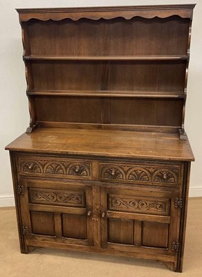 Lot 715 - A Priory style oak dresser, with brass hinges...