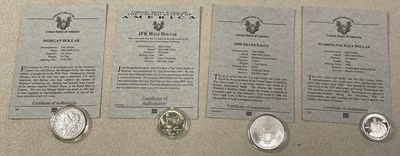 Lot 460 - American silver dollar and half dollar coins,...