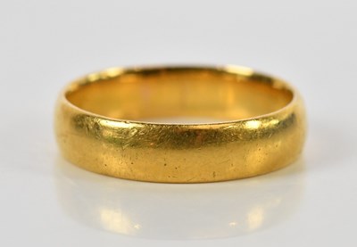 Lot 143 - A 22ct yellow gold wedding band, size N,...