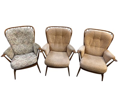 Lot 37 - ERCOL; a set of three medium elm spindle back...