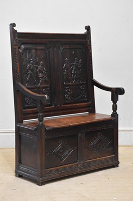 Lot 2069 - A late Victorian carved oak settle, the back...