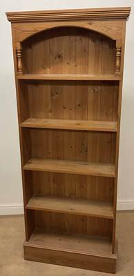 Lot 746 - A pine book shelf with arched top. 182 x 73 x...