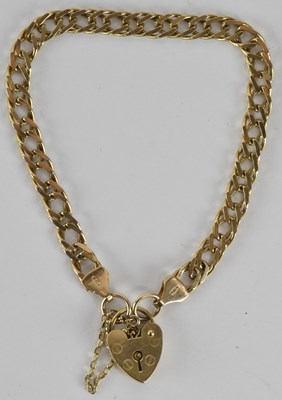 Lot 1598 - A flat curb bracelet, with 9ct gold heart...