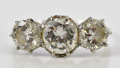 Lot 41 - A white metal three stone graduated diamond...