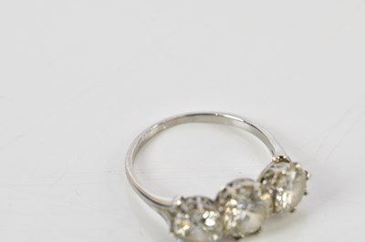 Lot 41 - A white metal three stone graduated diamond...