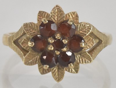 Lot 1353 - A 9ct gold garnet set flower cluster ring,...
