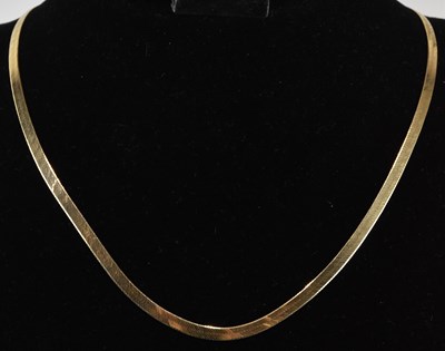 Lot 1443 - A 9ct gold flat link semi-rigid necklace, with...