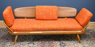 Lot 1404 - ERCOL; a light elm and beech daybed on turned...