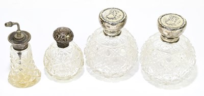 Lot 2384 - A group of four cut glass hallmarked silver...
