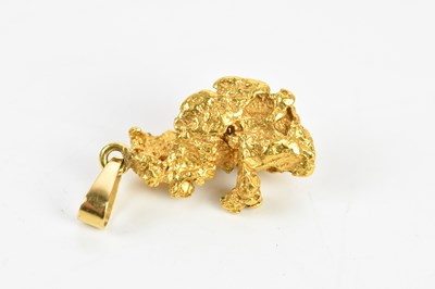 Lot 321 - A yellow metal nugget, unmarked suspended on...