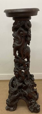 Lot 232 - A Chinese heavily carved jardinière stand,...