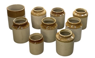 Lot 686 - A collection of nine stoneware jars, height of...